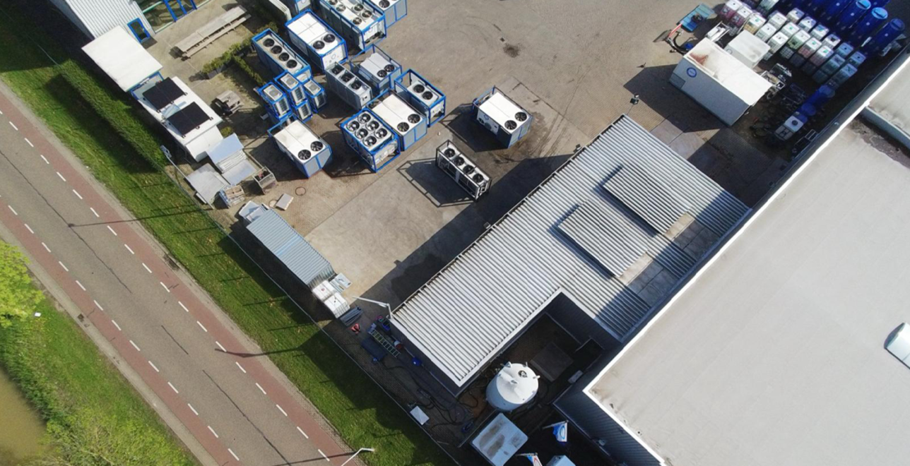 The installation at the Coolworld depot with the solar panels seen on the left and the test site on the right.